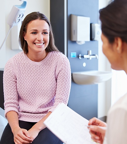 Woman in optometry office smiling at her optometrist