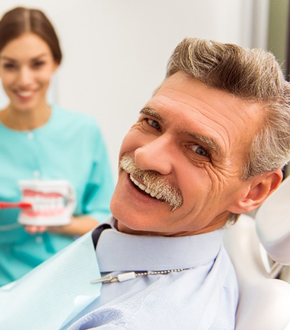 A dentist talking to his patient about all-on-4 implant candidacy