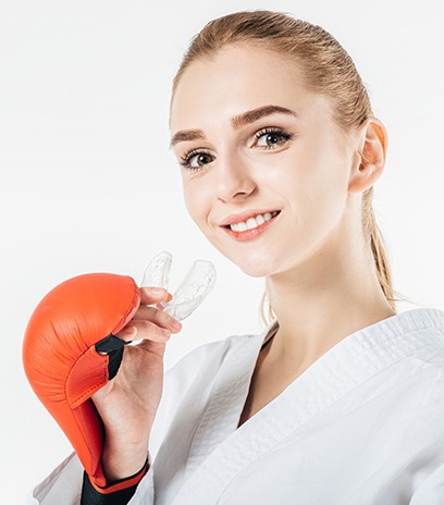 Teen girl placing an athletic mouthguard
