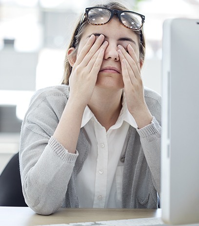 Woman with eye pain from staring at computer