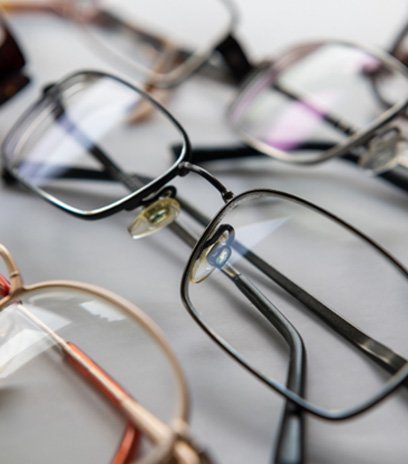 Close-up of several eyeglasses in a row