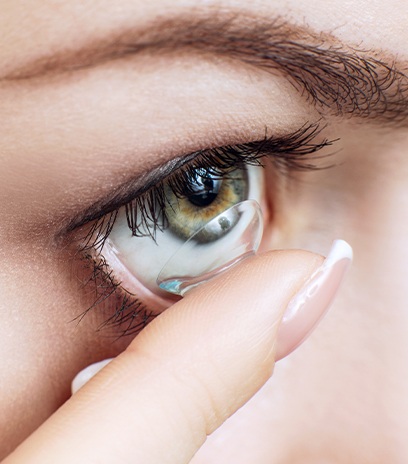 Woman placing scleral lenses