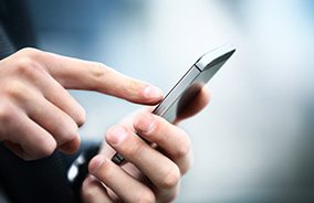 Close-up of person using finger to dial on a smartphone