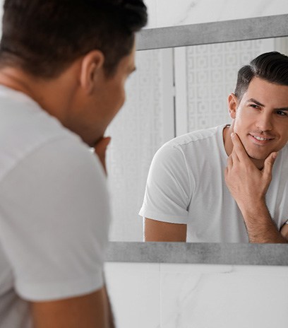 Man looking at his reflection in the mirror