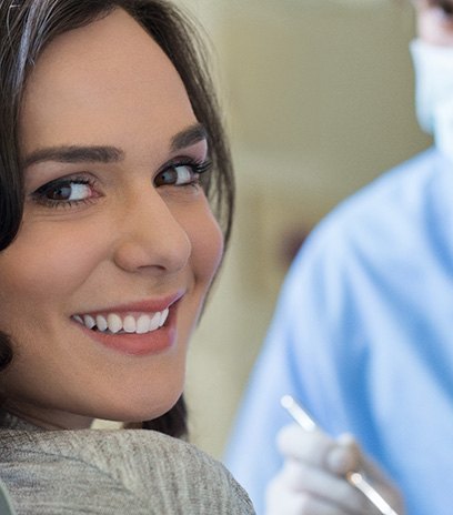 a patient smiling with a dental bridge in Belmont