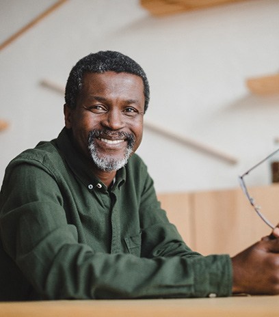 a man smiling with a dental bridge in Belmont