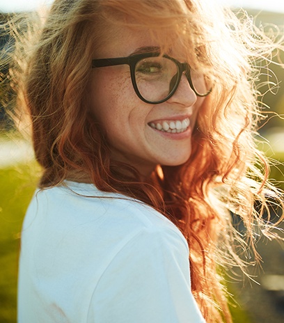Smiling woman with black plastic eyeglass frames