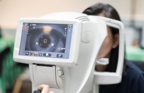 Patient receiving slit lamp exam of the inside of the eye