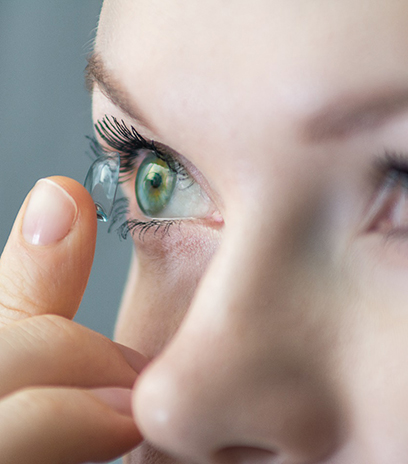 Woman putting contact lenses in her eyes