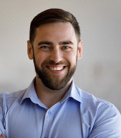 Man smiling after visiting cosmetic dentist in Belmont, MA