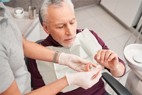 Man with dentures at the dentist