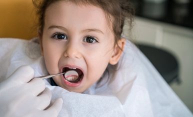 Little girl receiving children's dentistry exam