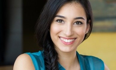 Woman with perfectly aligned smile after Invisalign treatment