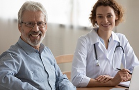 Dentist and older patient smiling