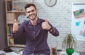 Man giving thumbs up wearing glasses with designer frames in Belmont, MA