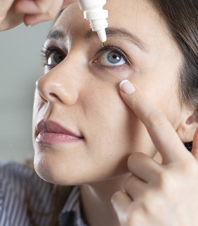 Woman using steroid eye drops