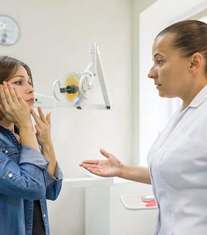 Emergency dentist speaking with a patient