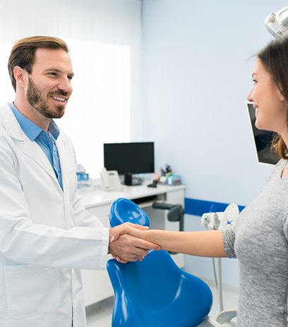 Dentist shaking hands with a patient