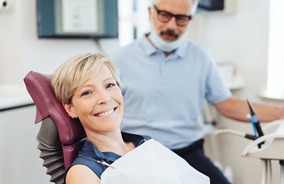 Female dental patient smiling before tooth extraction in Belmont, MA