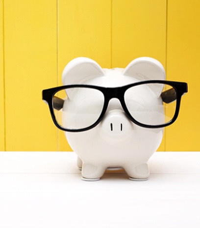 Piggy bank wearing glasses representing cost of eye exam in Belmont, MA