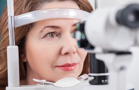 Woman having her eyes checked during routine eye exam in Belmont, MA