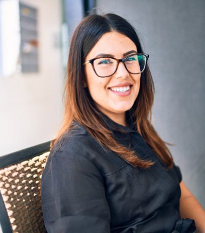 Woman with glasses sitting in a chair