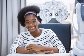 Young woman having an eye exam performed