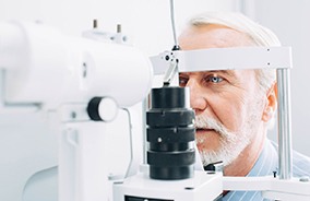 Man having an eye exam while visiting optometrist in Belmont, MA