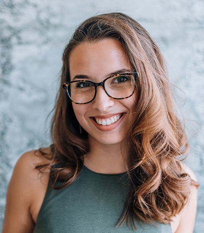 Smiling woman wearing her custom reading glasses