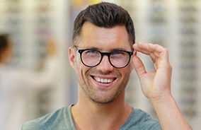 Smiling man with glasses with lenses that have anti reflective coating