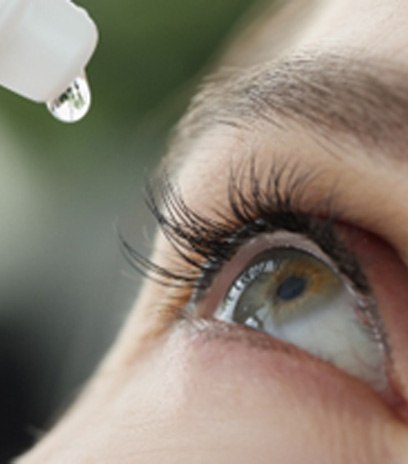 Woman using eye drops to treat dry eye