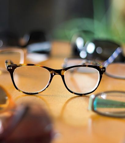 Collection of eyeglasses in Belmont, MA on table