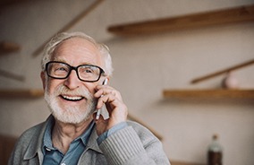 Man wearing eyeglasses in Belmont, MA and talking on phone