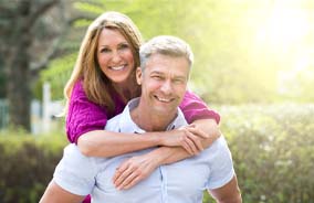 Couple smiling with dental implants in Belmont