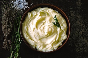 Mashed potatoes with garnish in a bowl 