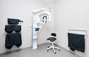Bearded man sitting in dental chair and smiling