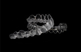 Close-up of two aligners for Invisalign in Belmont, MA