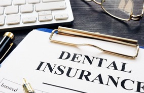 Dental insurance form on clipboard on a desk