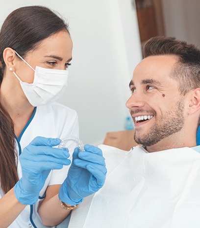dentist explaining Invisalign to patient in Belmont