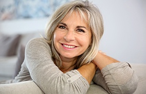 Older woman leaning on couch after visiting optometrist in Belmont, MA