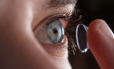 Person placing a contact lens