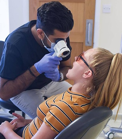 Dentist performing oral cancer screening