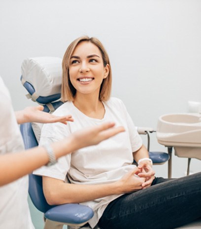 patient smiling while talking to dentist 