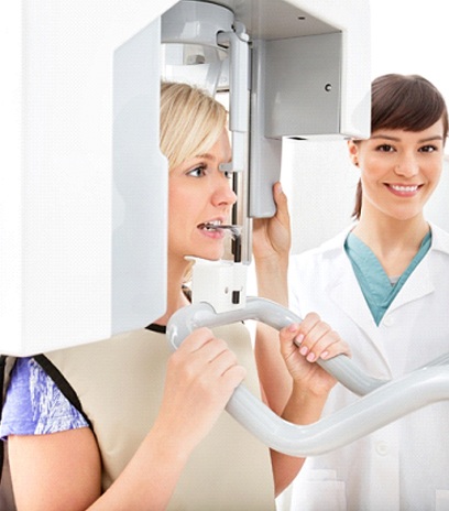 A dentist helping a patient complete a 3D scan.