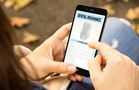 Woman filling out dental insurance form on phone