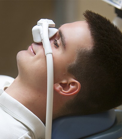 Man with nitrous oxide sedation dentistry mask in place