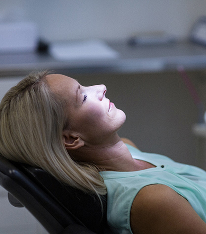 Woman relaxing in dentist's treatment chair