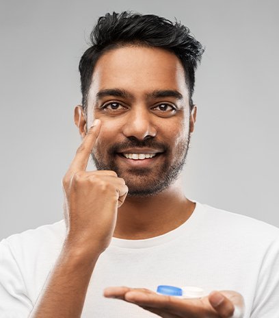 Man placing contacts for corneal refractive therapy