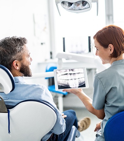dentist explaining TMJ options to patient 