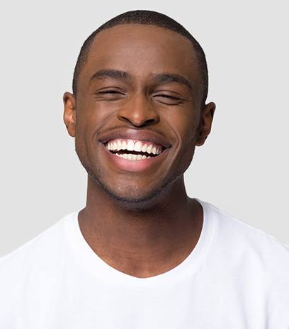 man smiling after getting veneers in Belmont